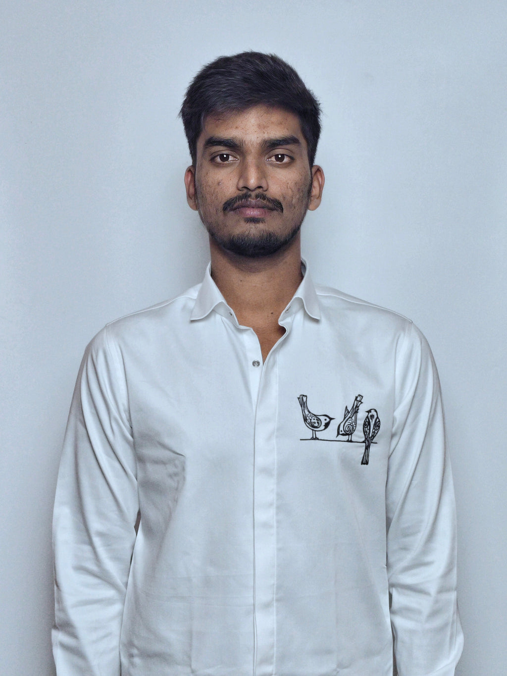 Artistic bird motif embroidery.